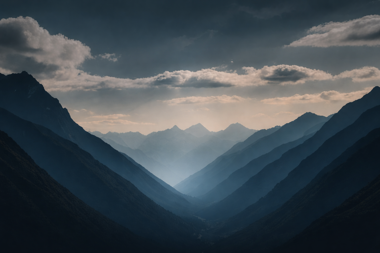 Dark mountain silhouettes with clouds